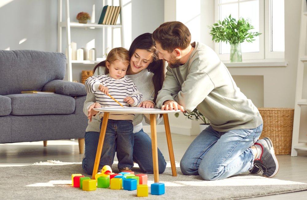 Happy,Parents,Playing,With,Their,Adorable,Baby,At,Home.,Mom